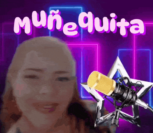 a woman is smiling in front of a microphone with the words muñequita written on it