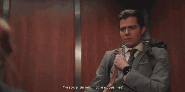 a man and woman in an elevator with the woman saying yeah maybe
