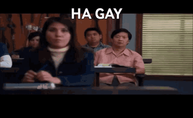 a group of people are sitting in a classroom and the words ha gay are above them