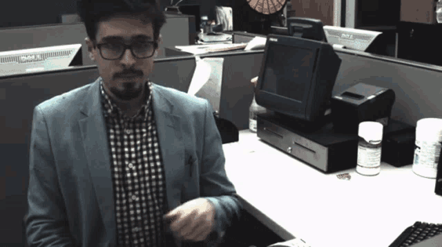 a man sitting at a desk with a dell monitor