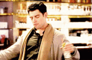 a man wearing a towel around his neck is holding a cup
