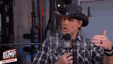 a man wearing a cowboy hat and plaid shirt is talking into a microphone with the bump logo in the corner