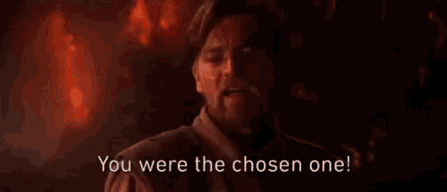 a man with a beard is sitting in front of a fire and saying `` you were the chosen one ! ''