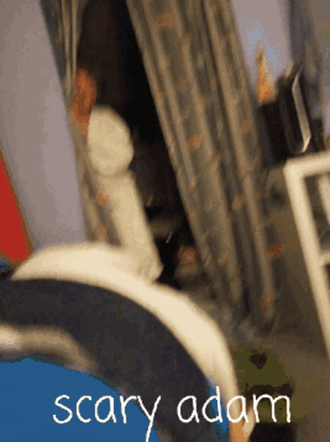 a scary adam poster with a person in the background