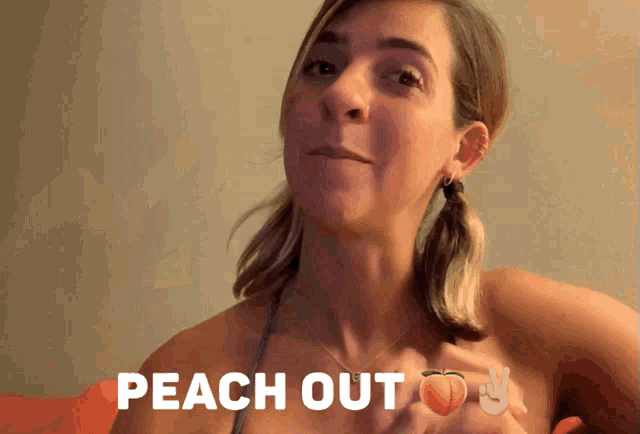 a woman holds up a peace sign and a peach with the words peach out above her