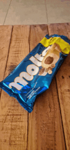 a bag of molly ice cream sitting on a wooden table