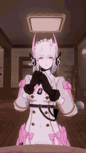 a girl in a maid outfit is sitting at a table with her hands folded in front of her face