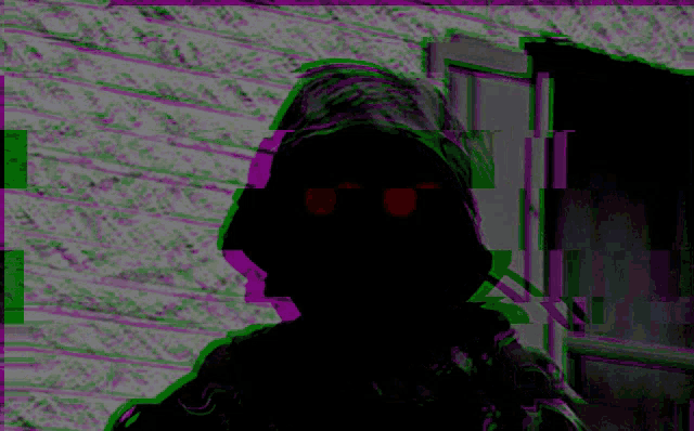a silhouette of a person with red eyes