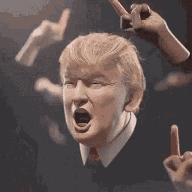 a close up of donald trump 's face with a lot of hands behind him .