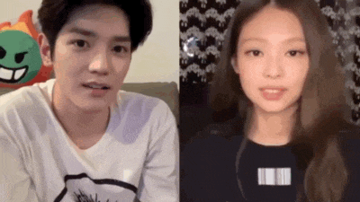 a man and a woman are sitting next to each other on a couch looking at the camera .