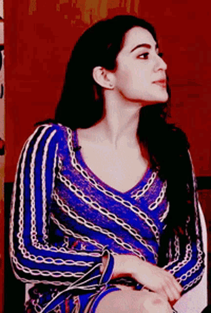 a woman wearing a blue and purple striped shirt
