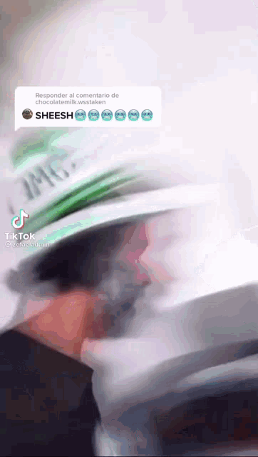 a blurred image of a man wearing a hat that says jmv on it