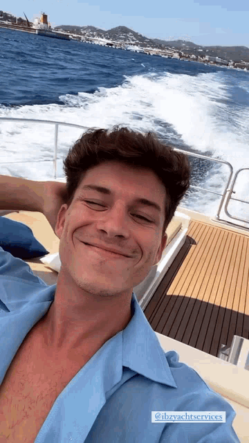 a man taking a selfie on a boat that says @ibyachtservices on the bottom