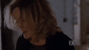 a blurred image of a person with the fx logo visible