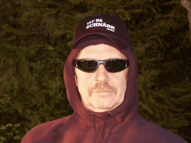 a man wearing a hat that says off da schnarb on it
