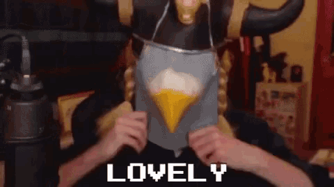 a person wearing a bird mask with the word lovely written on it