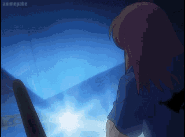 a girl in a blue shirt is standing in front of a blue wall and the word animegahe is on the bottom of the screen