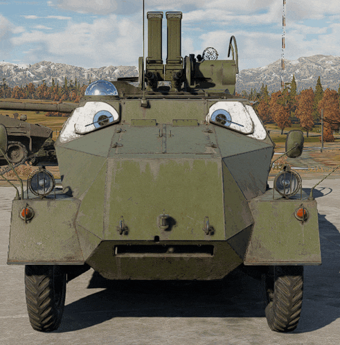 a green military vehicle with a smiley face painted on the side