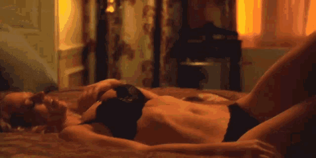 a woman in lingerie is laying on a bed with her legs crossed