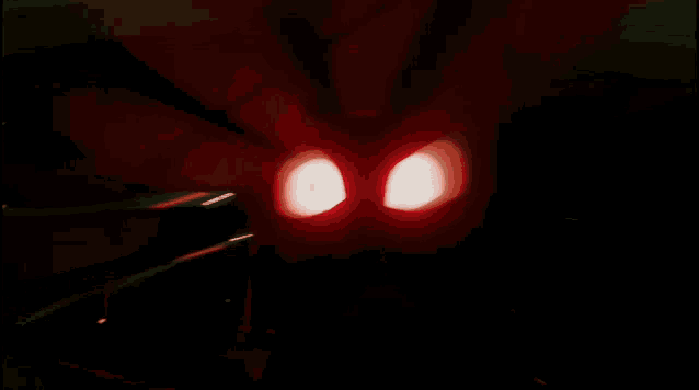 a close up of a person 's eyes in the dark