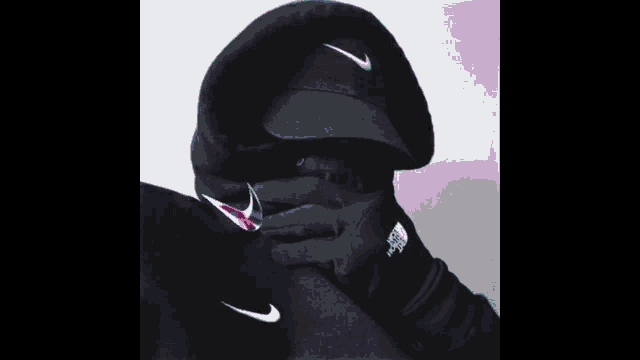 a person wearing a nike hat and gloves