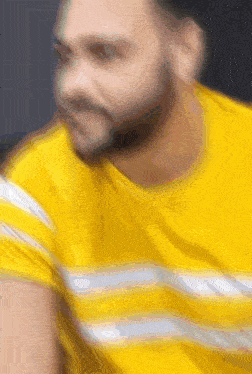 a blurry picture of a man wearing a yellow shirt
