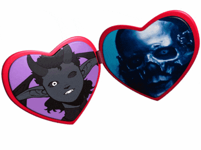 a heart shaped mirror has a picture of a demon and a skull on it