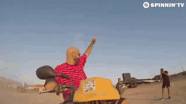 a man is riding a motorcycle on a beach .