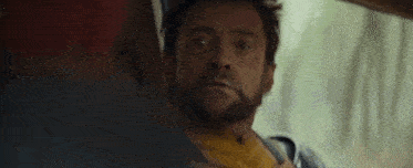 a close up of a person wearing a yellow jacket and black gloves in a dark room .