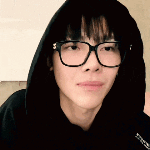 a close up of a person wearing glasses and a hoodie that says supreme