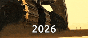 a group of people are standing in the desert next to a large machine that says 2026 .