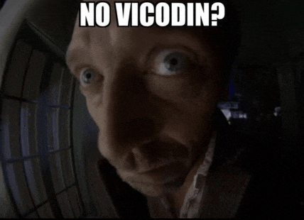 a man looking through a door with the words no vicodin written on his face