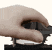 a close up of a person 's hand holding a remote control .