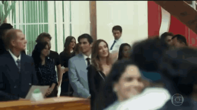 a group of people standing in a room with a circle in the middle that says ' o ' on it