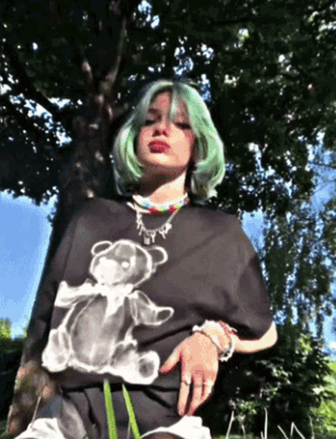 a girl with green hair wearing a teddy bear t-shirt
