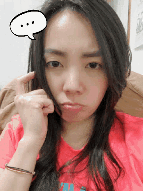 a woman in a pink shirt has a speech bubble over her head
