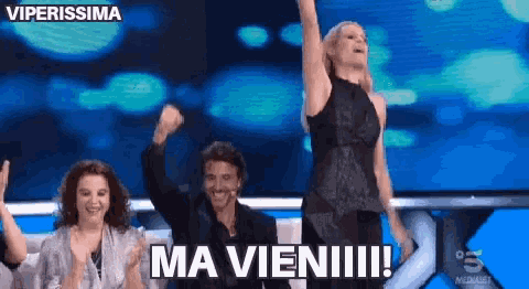 a group of people standing on a stage with the words ma vieni written on it
