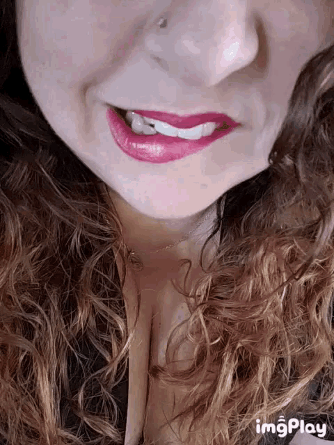 a close up of a woman 's face with the words imgplay visible