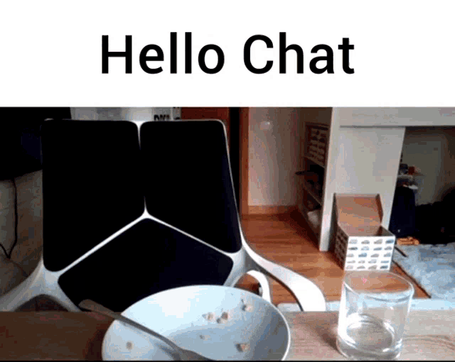 a bowl of cereal sits on a table next to a glass of water