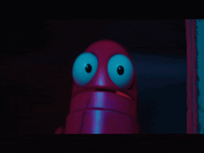 a close up of a purple object with blue eyes in the dark .