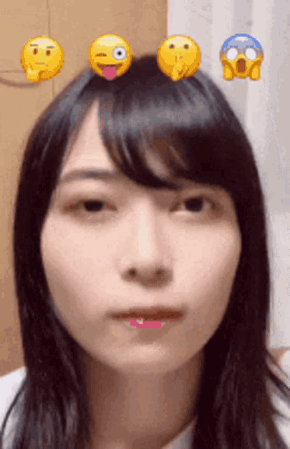 a woman with three emojis on her head