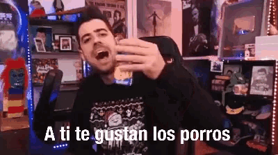 a man is taking a selfie in a room with the words a ti te gustan los porros