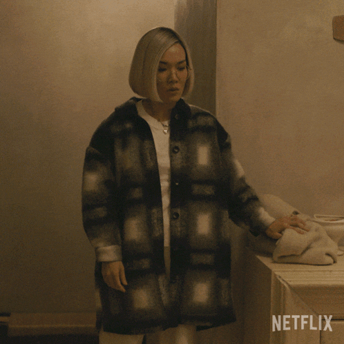 a woman standing in front of a netflix logo