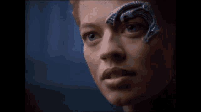 a close up of a woman 's face with a metal object on her face