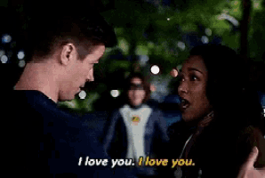 a man and woman are standing next to each other and the man is saying i love you .