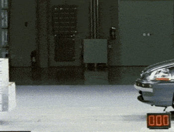 a car is parked in a garage next to a digital sign that says 000