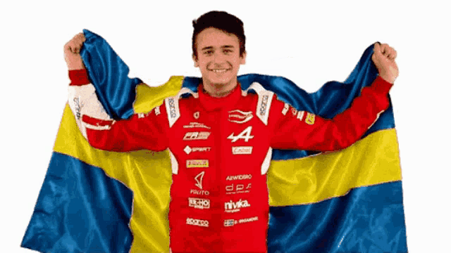 a man in a red jacket with the letter a on it is holding a flag