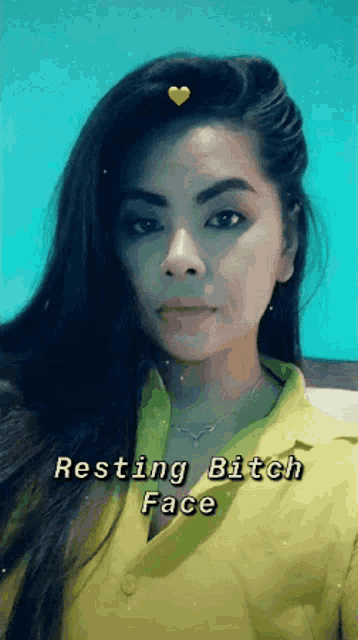 a woman in a yellow shirt has the words resting bitch face above her head