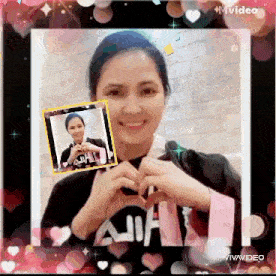 a woman is making a heart shape with her hands in front of a picture of her .