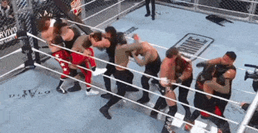 a group of wrestlers are fighting in a ring with the word prime written on the floor
